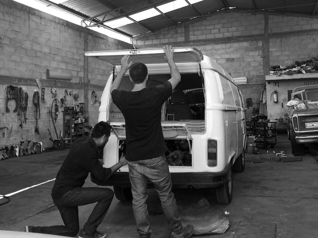 Peter and a Mexican mechanic inspecting a white VW t2 bus