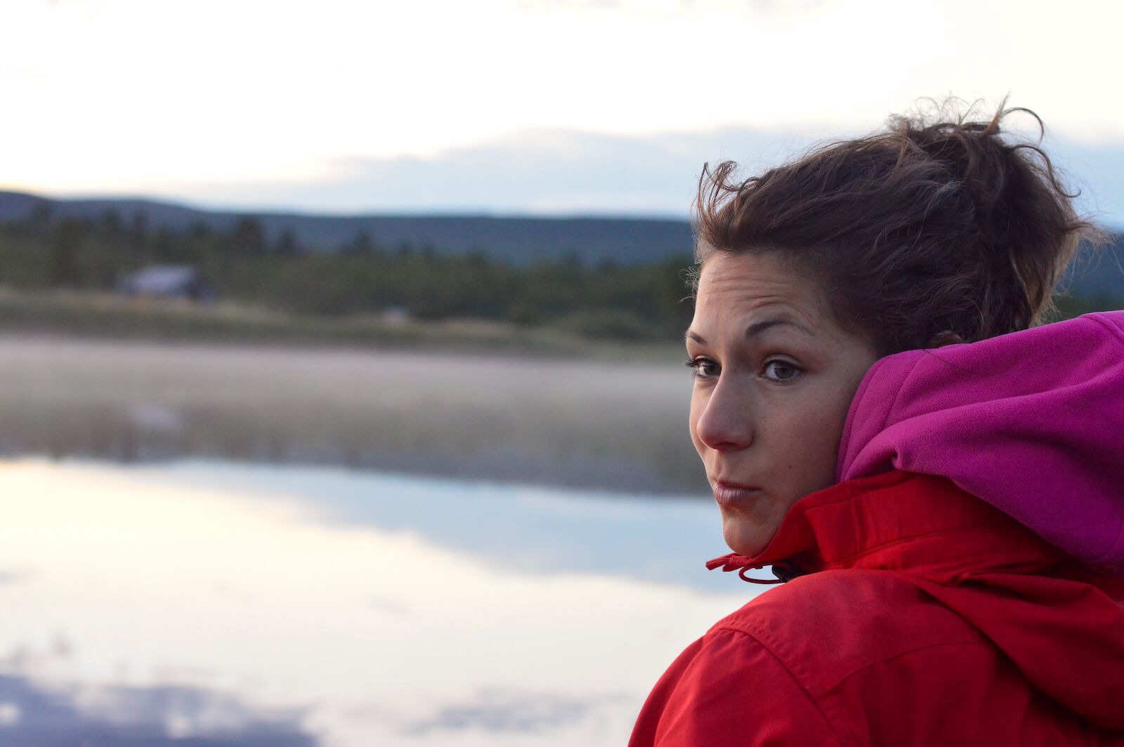 Sophie looking back over her shoulder in the evening in Lapland, Sweden
